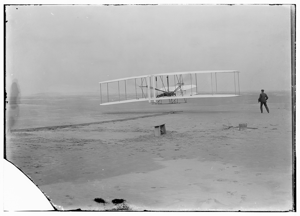 The Wright Flyer lifts off at Kill Devil Hills, December 17, 1903. Photograph by John T. Daniels, Library of Congress.